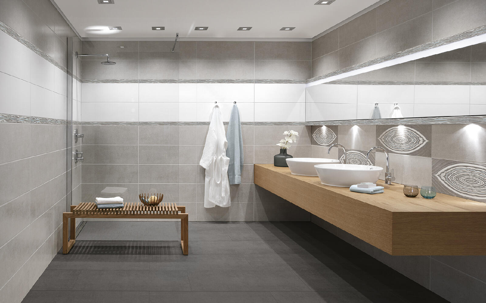 Badezimmer mit grauen Fliesen und Waschtisch aus Holz